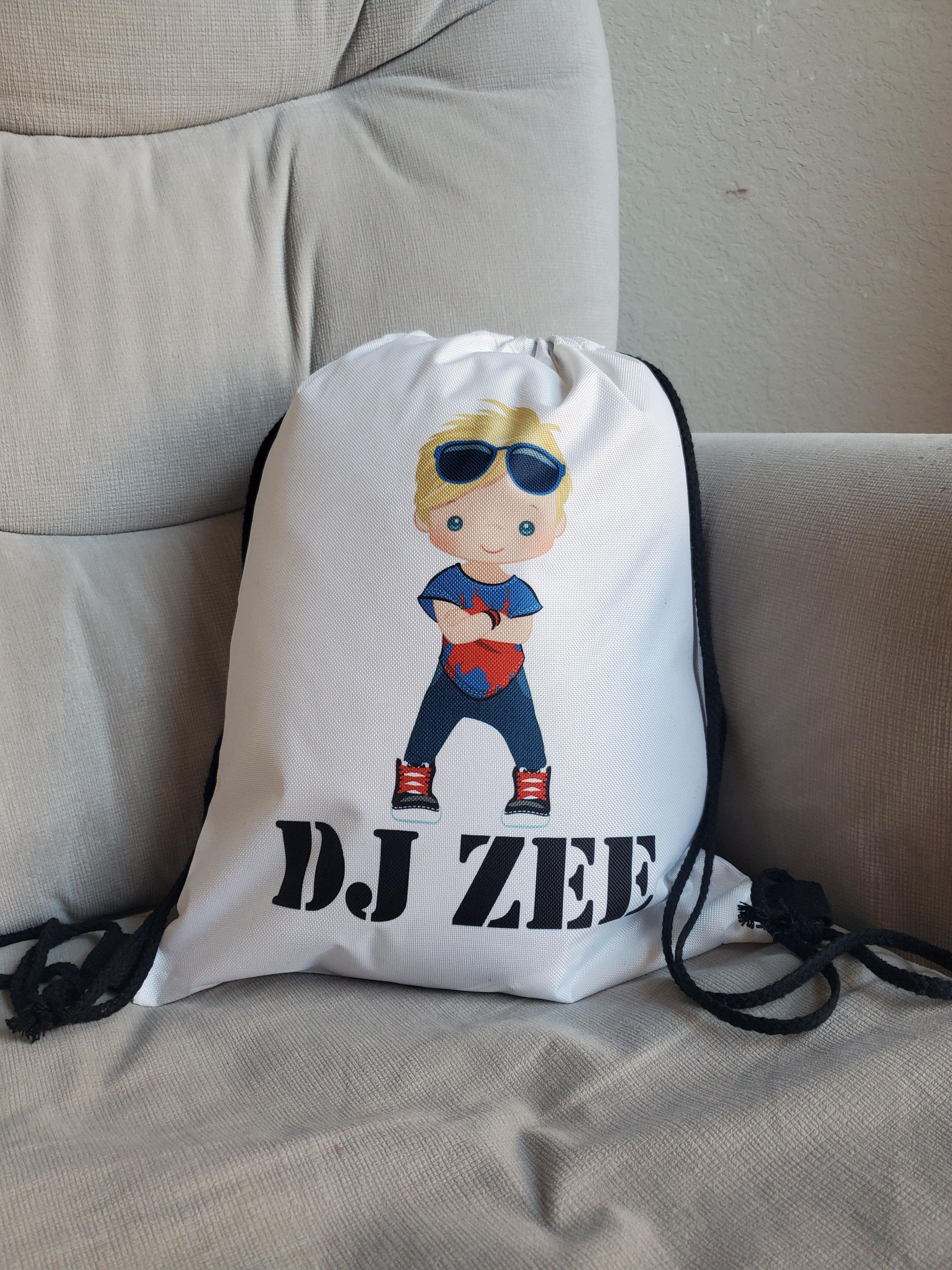 This is a white drawstring backpack customizable with the child's name and a boy in hip hop clothing. This makes a great unique gift for dance recitals for boys.