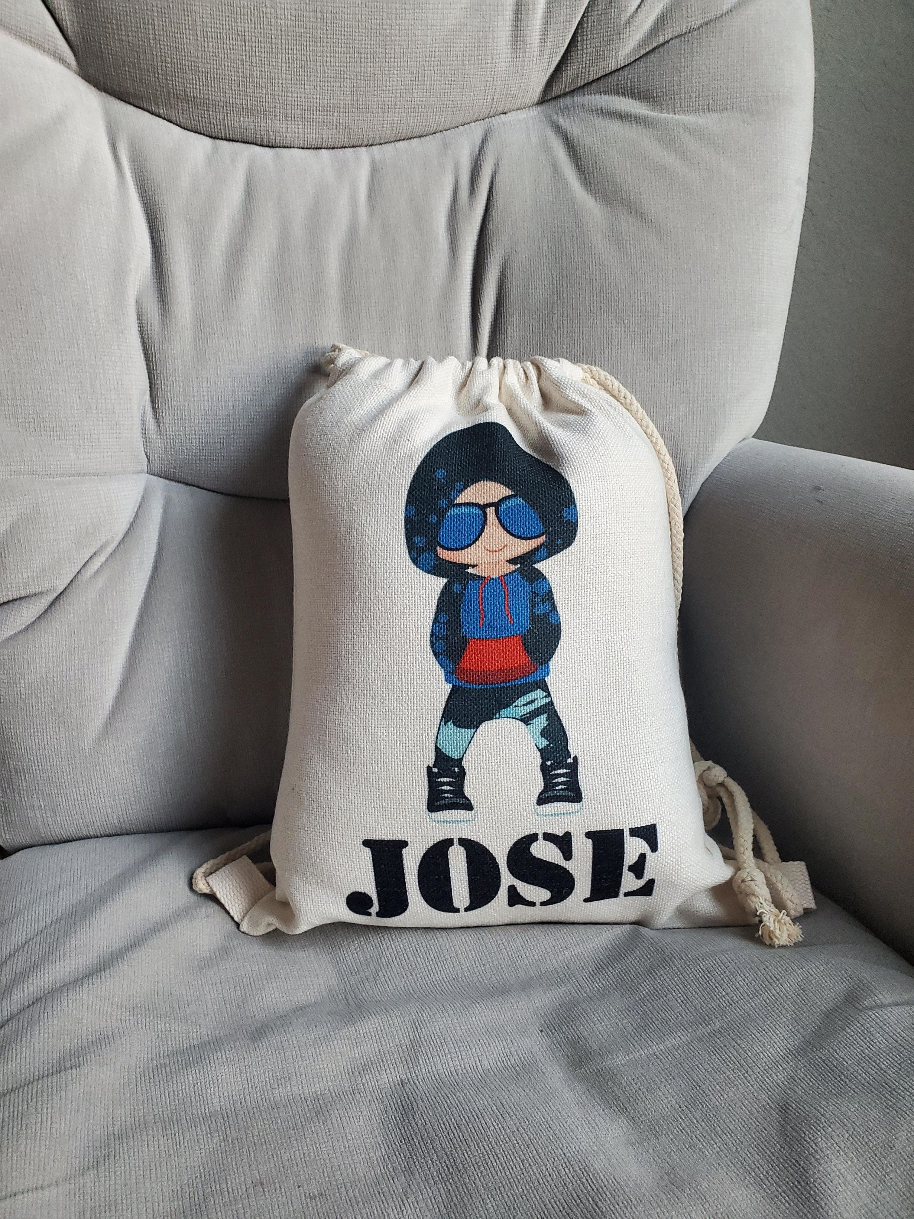 This is a white drawstring backpack customizable with the child's name and a boy in hip hop clothing. This makes a great unique gift for dance recitals for boys.