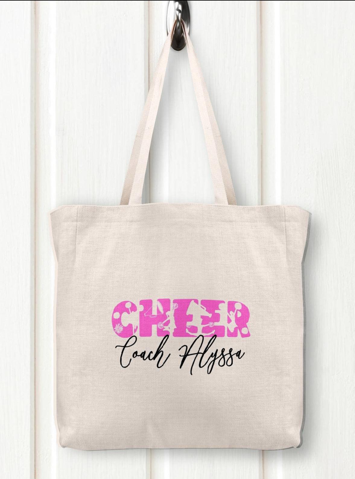 Custom Linen cheer tote with the words CHEER in pink and your custom text under neath the words CHEER centered on the tote.